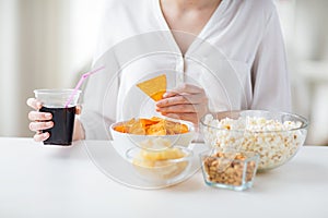 Close up of woman with junk food and coca cola cup