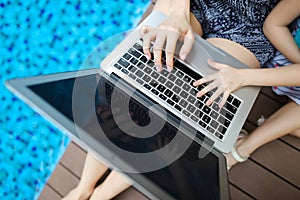 Close up woman and kid hands pressing keyboard on laptop sunny d