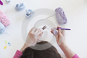 Close up of a woman knitting bootees for a baby