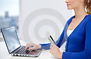 Close up of woman with laptop and credit card