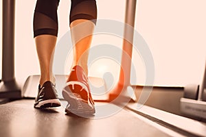 Close up of woman legs jogging on treadmill with sportwear and s