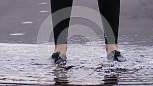 Close up woman legs jump in water, slow motion