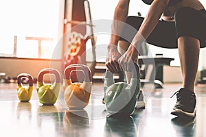 Close up of woman lifting kettlebell like dumbbells in fitness s