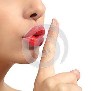 Close up of a woman lips with finger asking for silence photo