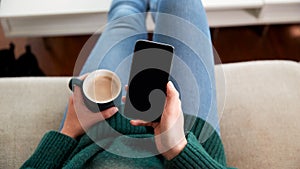 Close Up Of Woman Looking At Blank Screen With Copy Space On Mobile Phone Relaxing At Home