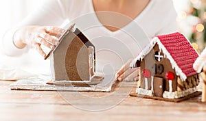 Close up of woman making gingerbread houses