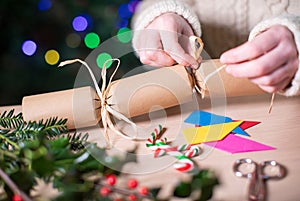 Close Up Of Woman Making Homemade Eco Friendly Christmas Cracker From Sustainable Materials