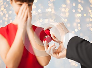 Close up of woman and man with engagement ring