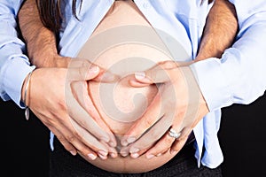 Close up of woman and man hands made heart on belly isolated on white background father mother health care love healthy pregnancy