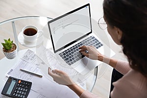 Close up of woman manage family budget on laptop