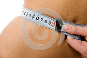 Close-up woman measuring her waist