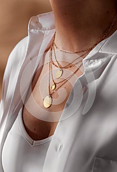 close up of woman with multi layer gold chains