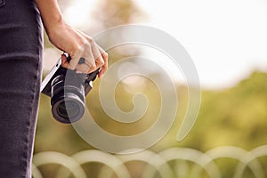 Close Up Of Woman Outdoors With DSLR Camera Taking Photos In City Park