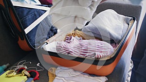 Close up of woman packing bags for holidays, girl preparing suitcase for vacations getting ready for travel