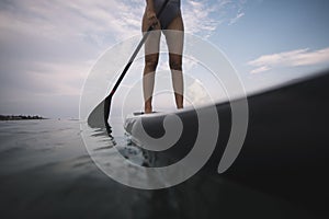 Close up of woman paddleboarding