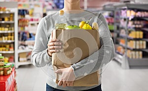 Close up of woman with paper bag full of food