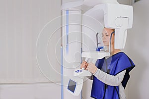 Woman patient doing panoramic teeth x-ray