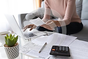 Close up of woman pay bills taxes on laptop