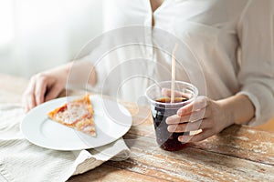 Close up of woman with pizza and coca cola drink