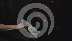 Close-up of woman playing piano. Media. Elegant woman plays piano in accelerated rhythm. Accelerated video of woman