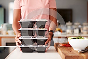 Close Up Of Woman Preparing Batch Of Healthy Meals At Home In Kitchen photo