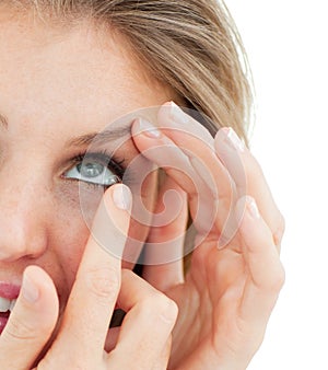 Close-up of a woman putting a contact lens