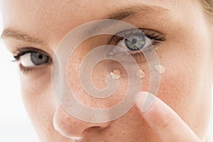 Close up of woman putting on make up