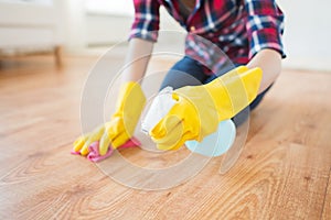 Close up of woman with rag cleaning floor at home