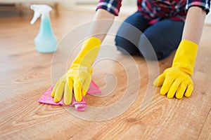 Close up of woman with rag cleaning floor at home