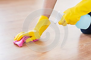 Close up of woman with rag cleaning floor at home