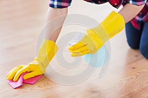 Close up of woman with rag cleaning floor at home