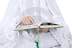 Close-up woman reading Kuran on white photo