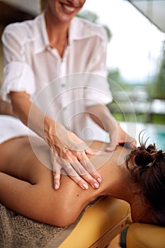 Close up of woman receiving back massage at salon spa