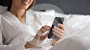 Close up of woman relax in bed using cellphone