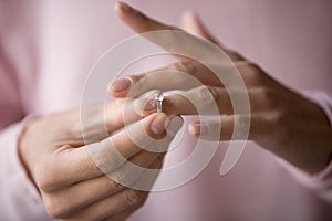 Close up of woman removing ring filing for divorce