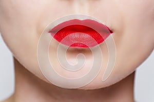 Close up of a woman's face wearing red lipstick