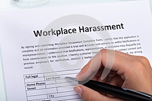 Woman Filling Workplace Harassment Form photo
