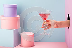 Close-up on woman`s hand holding a glass of red prosecco