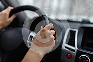 Close-up of woman& x27;s hand holding a steering wheel. Girl driver r