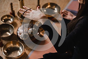 Close-up of a woman& x27;s hand holding Tibetan bells for sound therapy. Tibetan cymbals