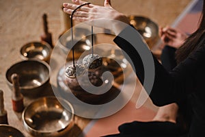 Close-up of a woman& x27;s hand holding Tibetan bells for sound therapy. Tibetan cymbals