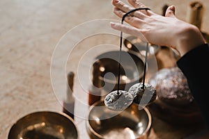 Close-up of a woman& x27;s hand holding Tibetan bells for sound therapy. Tibetan cymbals
