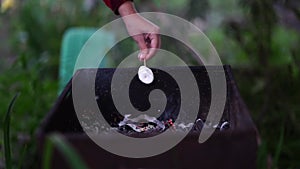 Close up of woman's hand holds skewer with marshmallow over chargrill. Female roasting zephyr on coals.