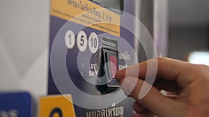 Close Up of Woman`s Hand Paying by Coins Subway Ticket in Automatic Vending Machine. 4K.