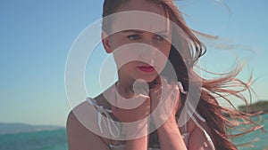 Close-up of a woman`s hand picking up a stone, and then throwing it from a palm on the beach.