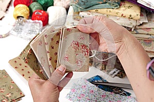 Close up of woman`s hand sewing patchwork