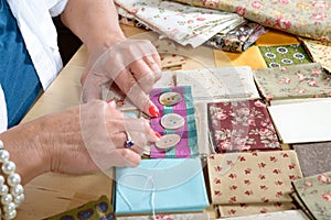 Close up of woman's hand sewing patchwork