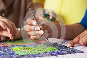 Close Up Of Woman's Hand Sewing Quilt