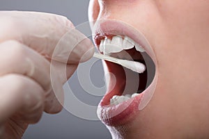 Woman Taking Saliva Test From Her Mouth photo