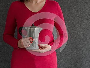 Close-up on a woman's hands holding a coffee maker